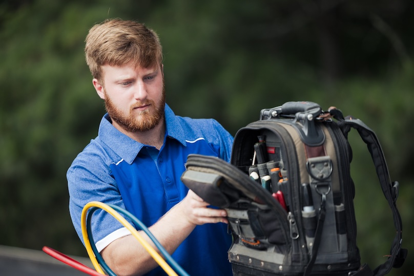 Superior Indoor Comfort technician putting tools in to his bag