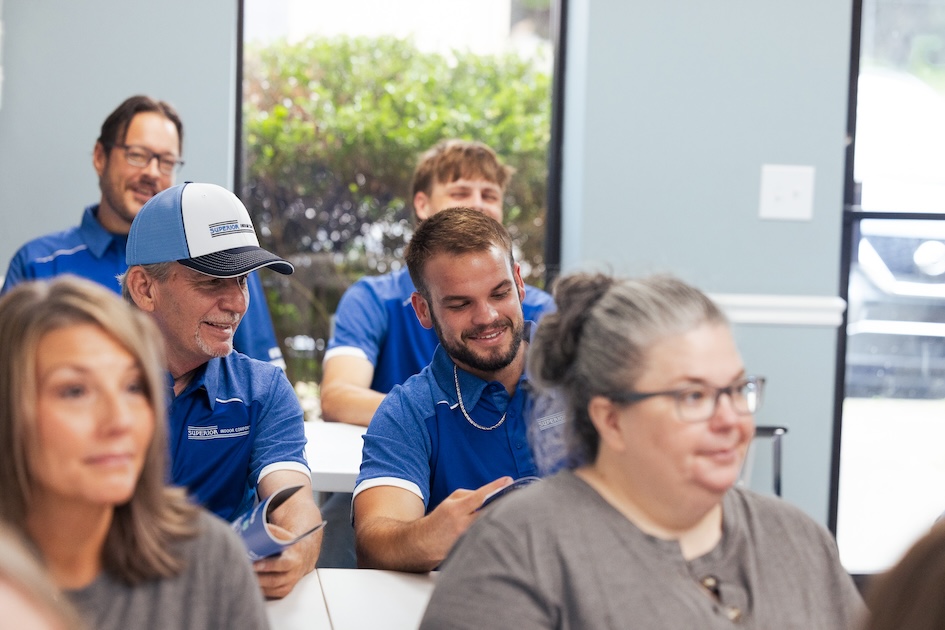Superior Indoor Comfort team sitting together in a meeting